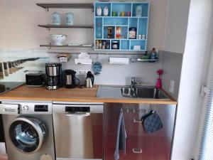 a kitchen with a sink and a washing machine at Glückstreffer in Meppen +15 photos