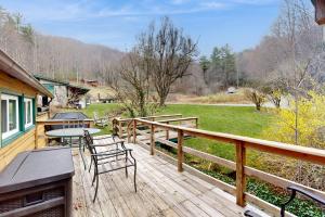 a wooden deck with a table and chairs on it at 1 Bed 1 Bath Vacation home in Sylva in Sylva