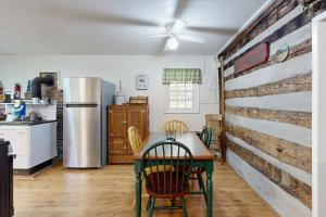 a kitchen with a table and a wooden wall at 1 Bed 1 Bath Vacation home in Sylva in Sylva