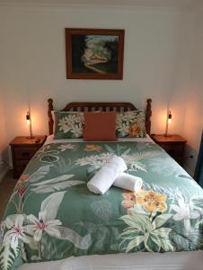 a bedroom with a bed with towels on it at Kereru Cottage in Kaikoura +11 photos