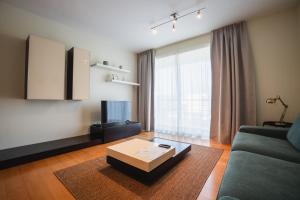 a living room with a couch and a coffee table at Charlotte's Place in Ponta Delgada