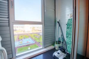 a window in a bathroom with a view of a pool at Charlotte's Place in Ponta Delgada