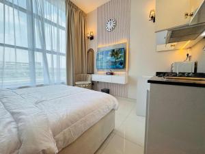 a bedroom with a bed and a kitchen with a clock at Al Manara Premium Deluxe Sheikh Zayed View Studio in Dubai +10 photos
