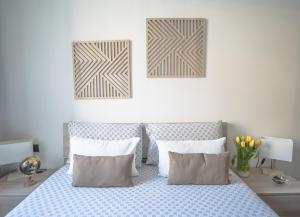 a bedroom with a bed with two pillows at Dolce Lago B&B in Calolziocorte