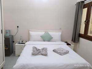 Letto o letti in una camera di HAWAKOM JABAL SHAMS REST house