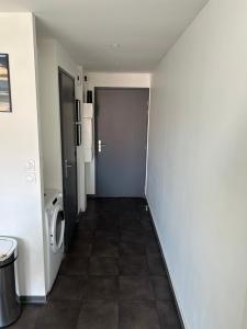a hallway of a bathroom with a washing machine at Le Channel in Camiers +6 photos