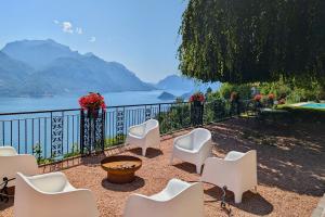 a patio with chairs and a view of the water at Chalet Miralago in Plesio +36 photos