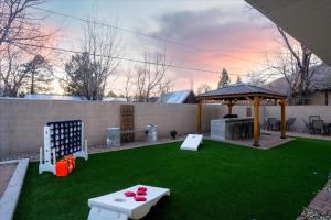 a backyard with a ping pong table and a gazebo at Sleeps 18 Hot Tub Pool Table Fire Pit Arcade Game in Flagstaff