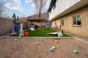 a backyard with a lawn with balls on it at Sleeps 18 Hot Tub Pool Table Fire Pit Arcade Game in Flagstaff