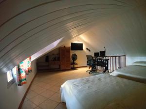 a bedroom with a bed and a desk in a room at Samara Beach Las Palmeras Condo with Ocean view in Sámara +56 photos