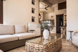 a living room with a couch and a table at Fasolaki Skopelos - Eco Residences in Skopelos Town