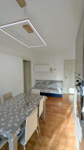 a room with a table and chairs and a bed at Il granchio in Marcelli