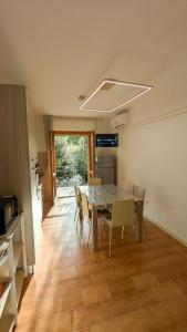 a kitchen and dining room with a table and chairs at Il granchio in Marcelli