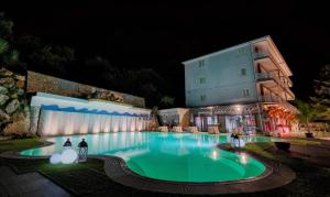 a large pool in front of a building at night at Lux Home & Garden in Lago