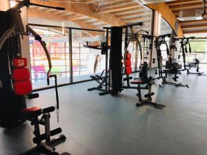 a gym with a bunch of treadmills and machines at Studio Ștefan in Călimăneşti
