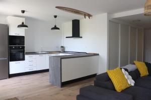 a living room with a couch and a kitchen at Homestay in Málaga