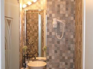 a bathroom with a toilet and a sink and a shower at The Kiss Apartment in Timişoara