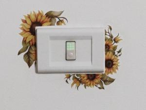 a light switch with a flower design on a wall at La casa di Elena a San Gregorio di Catania in San Gregorio di Catania