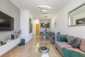 a living room with a couch and a table at Calpe Vacaciones in Calpe