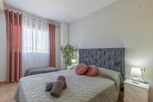 a bedroom with a bed with two towels on it at Calpe Vacaciones in Calpe +21 photos