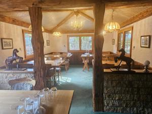 a restaurant with tables and chairs and a horse statue at Le Cavalier Delémont in Soyhières