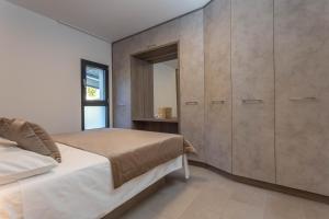 a bedroom with a bed and a large cabinet at Grey House in Bol +41 photos
