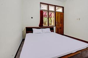 Ένα ή περισσότερα κρεβάτια σε δωμάτιο στο Hotel O Losmen Tjabe Merah Near Alfamart Bintaro +18 φωτογραφίες