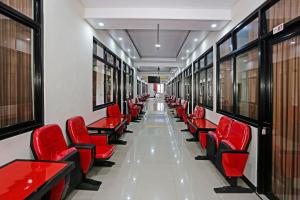 a row of red chairs in a corridor at Hotel O Tjokro 3 in Bogor +37 photos
