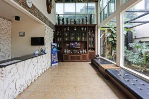 a large room with a bar with windows at Hotel O Tjokro 3 in Bogor +39 photos