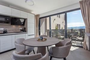 a kitchen and dining room with a table and chairs at Grey House in Bol