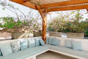 a wooden pergola with a couch on a patio at Casa Guerrero in Cartagena de Indias