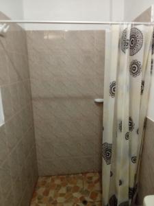 a shower with a shower curtain in a bathroom at Casablanca beach in Los Órganos +11 photos