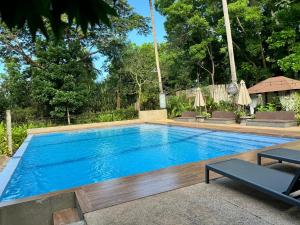 a large swimming pool with blue water at E-Place Resort in Magallanes