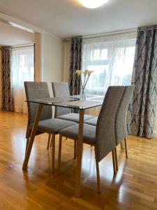 a dining room with a glass table and chairs at The White Lodge Hotel in Hereford