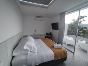 Postel nebo postele na pokoji v ubytování Hotel PAUCHÉ Topiario Zapatoca