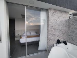 Postel nebo postele na pokoji v ubytování Hotel PAUCHÉ Topiario Zapatoca