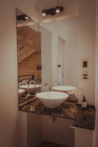 a bathroom with three sinks and a large mirror at Pentagrama, casas de campo in Villa General Belgrano