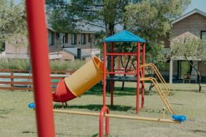 a playground with a slide in a park at Pentagrama, casas de campo in Villa General Belgrano