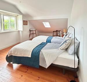 a bedroom with two beds and a window at DOMUS QUIETA Pool near beach in Colares +32 photos