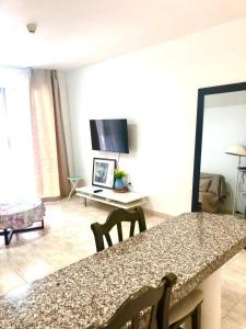 a kitchen and living room with a table and chairs at Comfort in Playa las Americas in Playa de las Americas