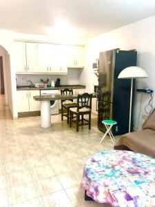 a kitchen and living room with a table and chairs at Comfort in Playa las Americas in Playa de las Americas