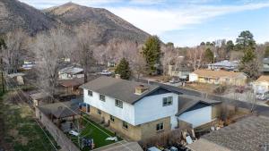 an aerial view of a house with mountains in the background at Sleeps 18 Hot Tub Pool Table Fire Pit Arcade Game in Flagstaff