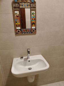 a bathroom with a sink and a mirror on the wall at Tunis Vista in Tunis +19 photos