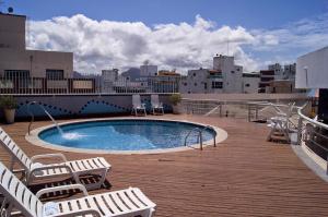 a swimming pool on the roof of a building at Studio Costa a Mar in Guarapari
