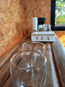 two wine glasses sitting on top of a wooden table at Ecolodge La Corocora in Monterrey +23 photos