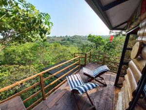 a wooden deck with two chairs and a table on it at Ecolodge La Corocora in Monterrey +24 photos