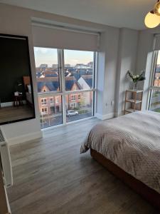 a bedroom with a bed and a large window at Two Three North in Balgriffin
