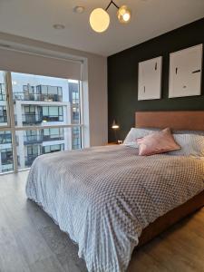 a bedroom with a large bed and a large window at Two Three North in Balgriffin