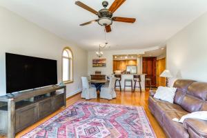 a living room with a couch and a flat screen tv at Near Hiking and Biking Mtn-View Condo in Angel Fire in Angel Fire