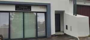 a building with glass doors and a sign on it at Santa Beatriz Apartment in Machico